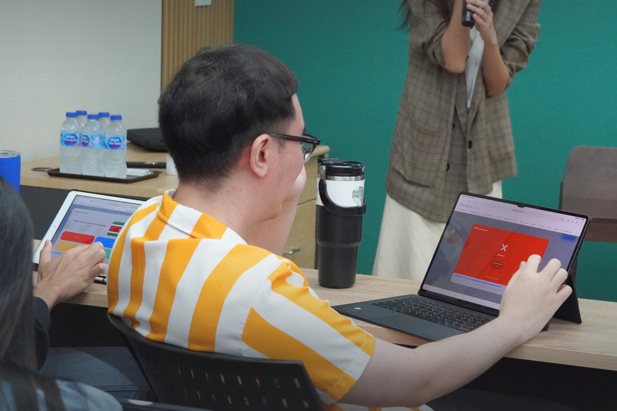 Teacher trying out the RevisionSuccess platform during the workshop at House of Griffin