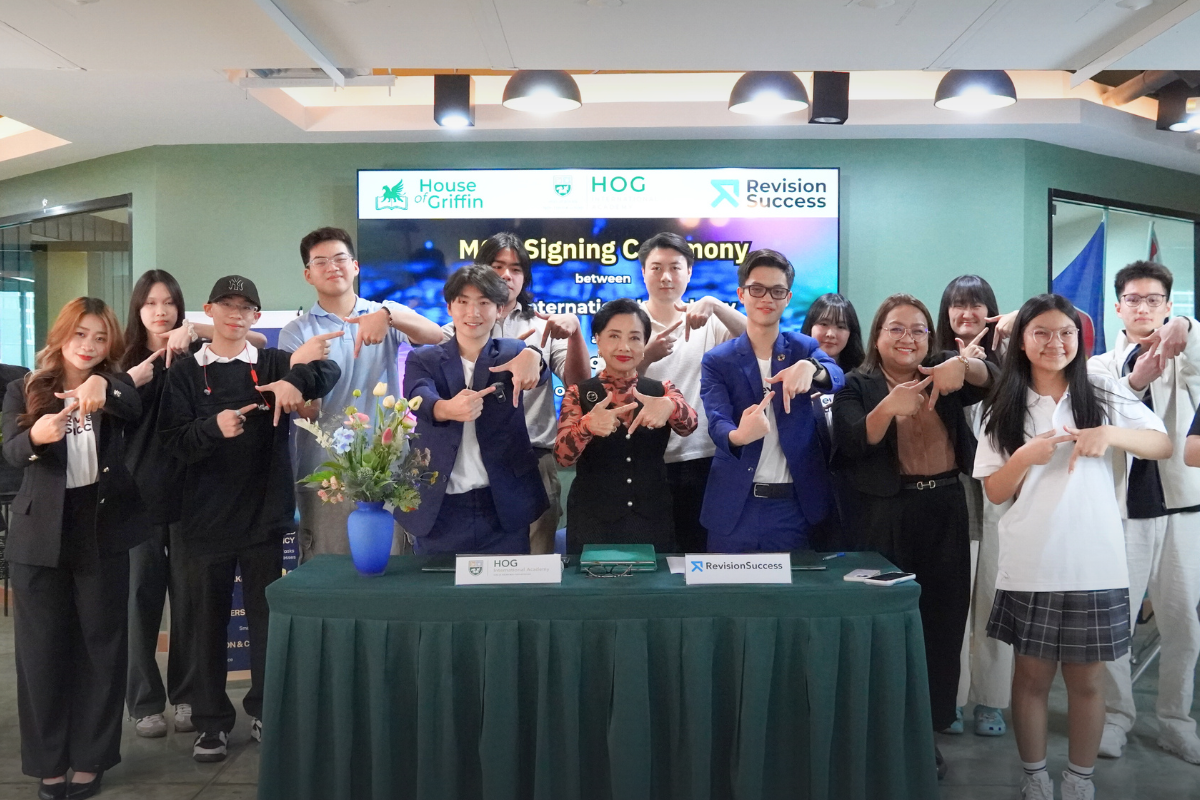 Group photo of representatives and attendees from RevisionSuccess and HOG International Academy following the MOU signing