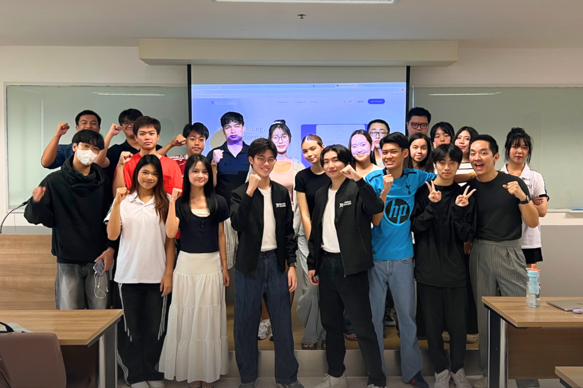 Phonlawat Sirajindapirom and Phuwadit Sutthaporn with students of the International College, Sripatum University, in front of RevisionSuccess on screen